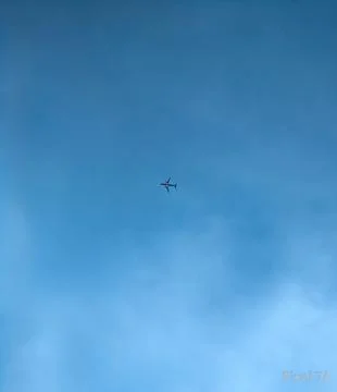 The plane looked so small from below Stock Photos
