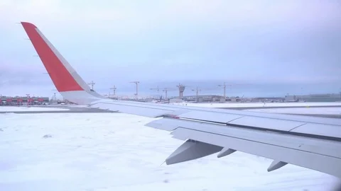 The plane moves on the runway. View of the wing of the plane, on the background Stock Footage 72255692