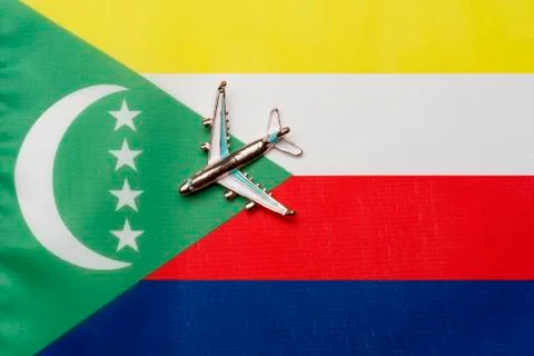 Plane over the flag of the Comoros the concept of travel. Stock Photos
