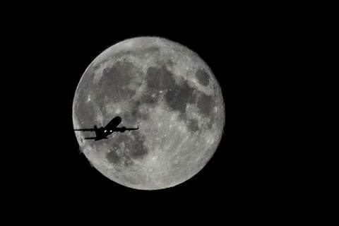 Plane over moon Photos