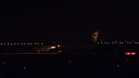 A plane is parked on the runway at night Stock Footage 291899347