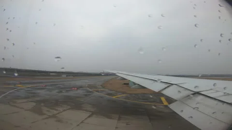 The plane parked on the runway ready to take off on a rainy day Video stock 146314246