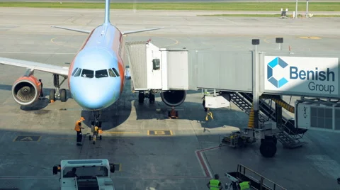 A plane is parked for the tunnel to be attached Stock Footage 65532441