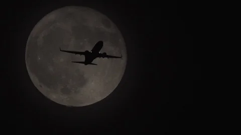 Plane passing full moon - 4K UHD stock video Stock Footage 104613974