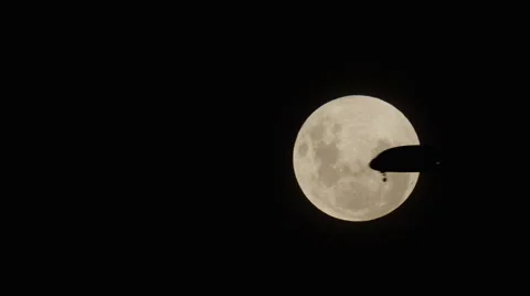 Plane passing by Full Moon 6k Stock Footage 62550283