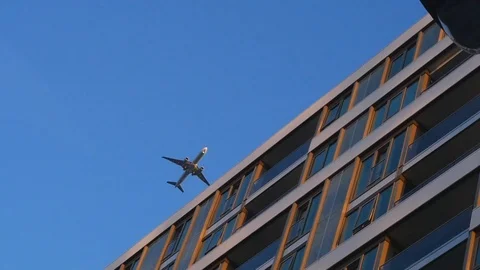 Plane passing over a building Stock Footage 96465801