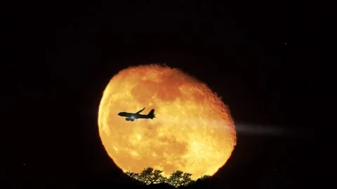 Plane Passing Over a super Moon Stock Footage 233658874