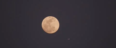 Plane passing over Super Moon Stock Footage 277933331