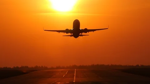 Plane passing the sun after takeoff Stock Footage 106307881