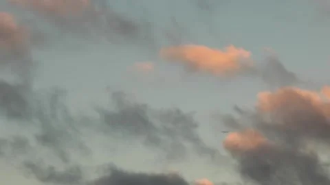 Plane Passing Through Blue and Orange Afternoon Clouds 스톡 동영상 143563342