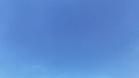 Plane Passing Through Clear Blue Sky – 4K Drone Footage Stock Footage 319751388