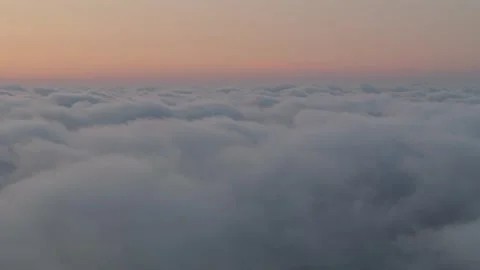 Plane perspective at sunset, cruising over clouds. Orange sunbeams highligh.. Video stock 281325507