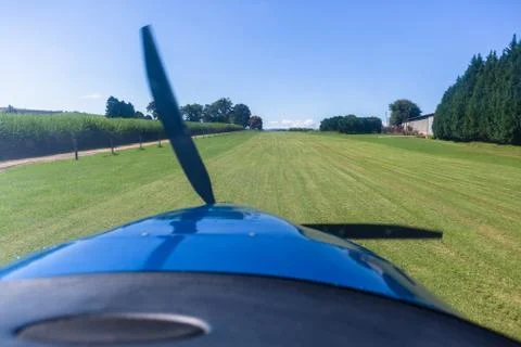 Plane  Pilot view Takeoff Approach Grass Runway Farm. Stock Photos