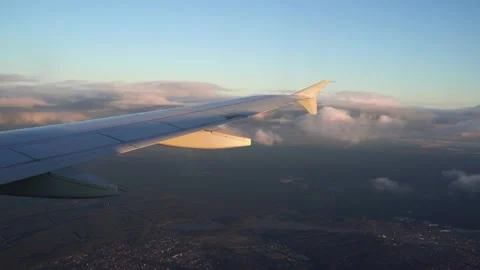 The plane is preparing to land. The wing of the plane can be seen from the Stock Footage 161868421