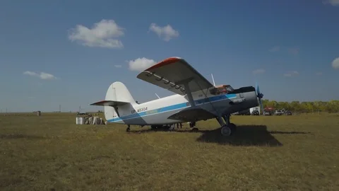 The plane is preparing to take off. On the background of the field Stock Footage 102370276