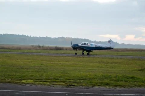 Plane preparing to take off in cloudy evening Stock Photos