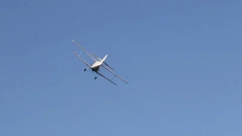 A plane with a propeller flies in the blue sky Stock Footage 107653268
