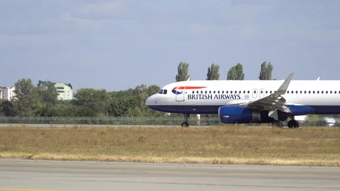 Plane ready for take off rolls on runway at airport. 4K Stock Footage 117182773