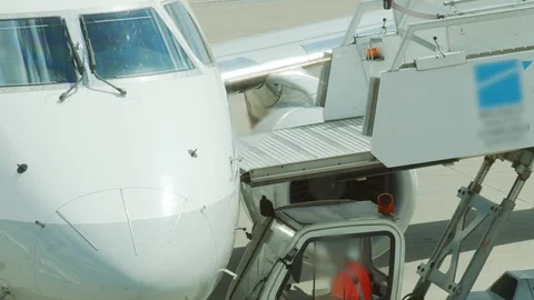Plane ready to take off. Workers on airplane track detaching staircase or air Stock Footage 110924027