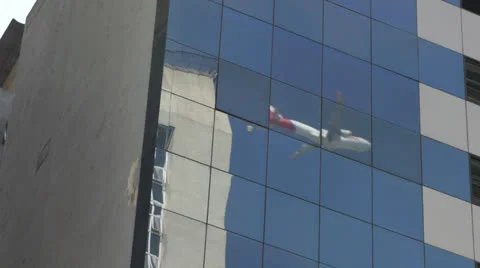 Plane reflected in the glass building Stock Footage 27140913
