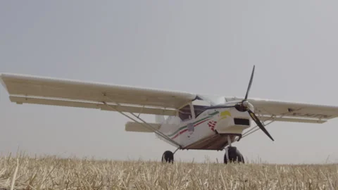 Plane on a runway in a field Stock Footage 275383716