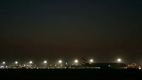 Plane on runway at night Stock Footage 77046071