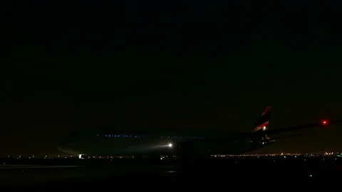Plane on runway at night Stock Footage 77101014