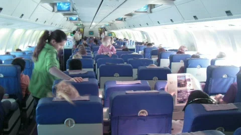 Plane salon: passengers sit, stewards approach to passengers Stock Footage 693490
