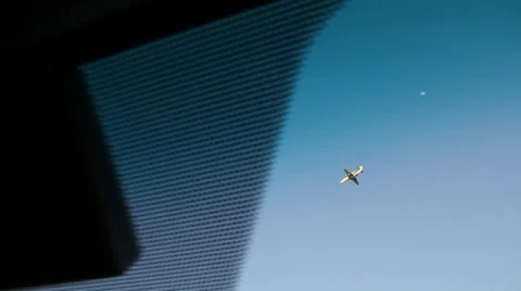 Plane seen thru car window then pan to traffic Stock Footage 52813740