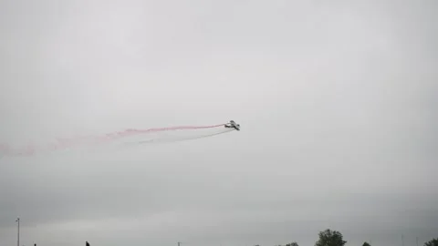 Plane in the Sky with Green, White, and Red Smoke Trail (Italy) in Slow Motion Stock Footage 279969805