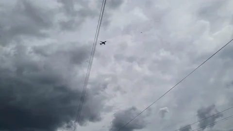 Plane in the sky, silhouette of an airplane in the cloudy rainy sky Stock Footage 201527875