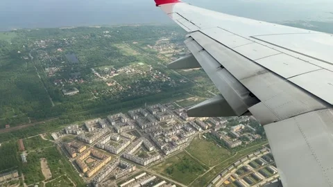The plane slowly turns left over the city during the flight Stock Footage 294586920