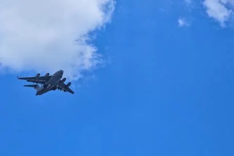 A plane soaring with a cloud backdrop. Stock-Fotos
