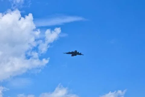 A plane soaring high in the sky. Stock Photos