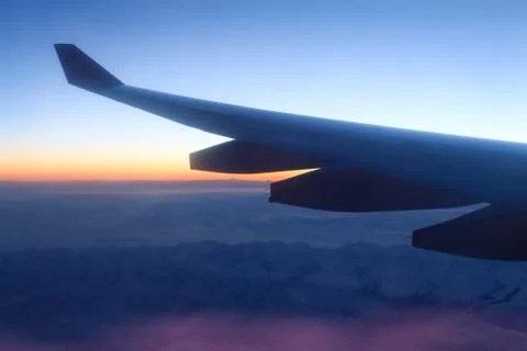 Plane at sunset. Stock Photos