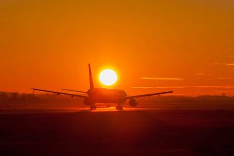 Plane take off in sunset Stock Photos