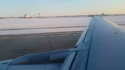 The plane takes off on the background of snow-covered field. The plane picked up Stock Footage 199486720