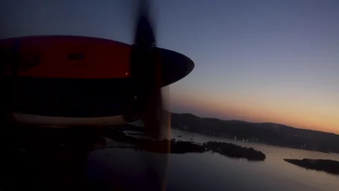 Plane takes off. Propeller turns against background of sky and sea. Stock Footage 255246744