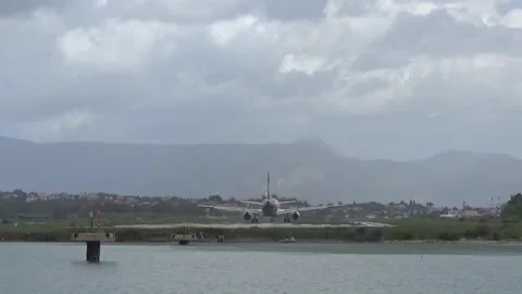 The plane takes off from the runway at Corfu airport. View close. Stock Footage
