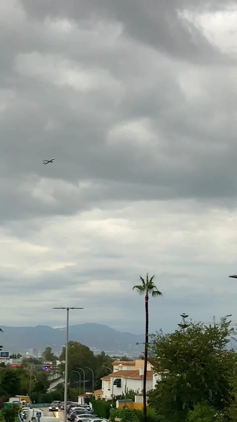 The plane takes off sharply, avoiding a storm cloud in Torremolinos, Spain Stock Footage 300025440