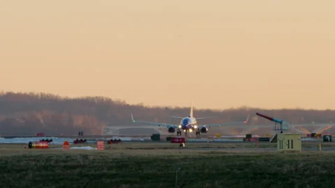 Plane Takes Off At Sunset With Bold Orange Sky In Washington D.C. Stock Footage 169279056