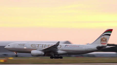 Plane takes off at sunset etihad airways airbus a330 Stock Footage 26284685