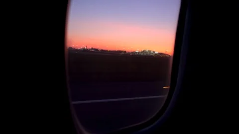 The plane takes off at sunset. View from the airplane window Stock Footage 115365360