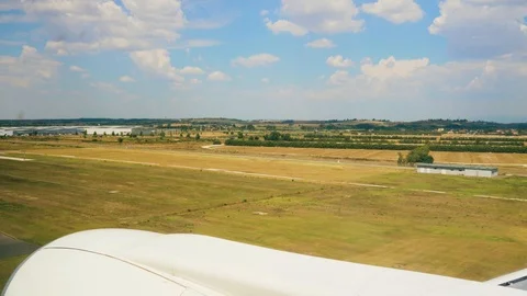 Plane takes off. View from the porthole on the wing of the plane 4k Stock Footage 107746033