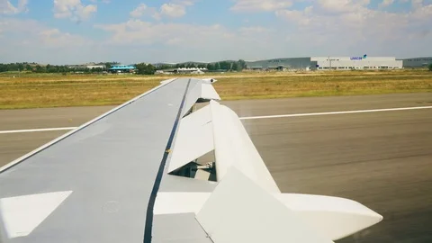 Plane takes off. View from the porthole on the wing of the plane 4k Stock Footage 107746528