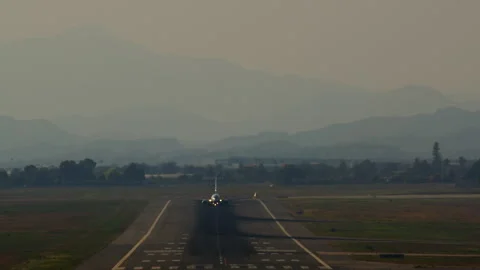 Plane taking off against mountain backdrop Stock Footage 263080133
