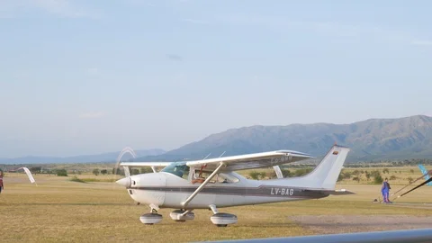 Plane taking off from the airport with mountains in the background Stock Footage