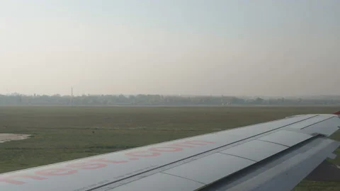 Plane taking off from airport, View through an airplane window Stock Footage 98287182