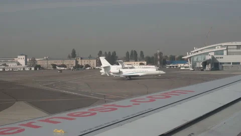 Plane taking off from airport, View through an airplane window Stock Footage 98288021