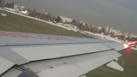 Plane taking off from airport, View through an airplane window Stock Footage 98289706
